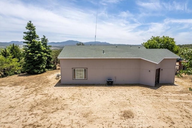 rear view of house featuring a mountain view