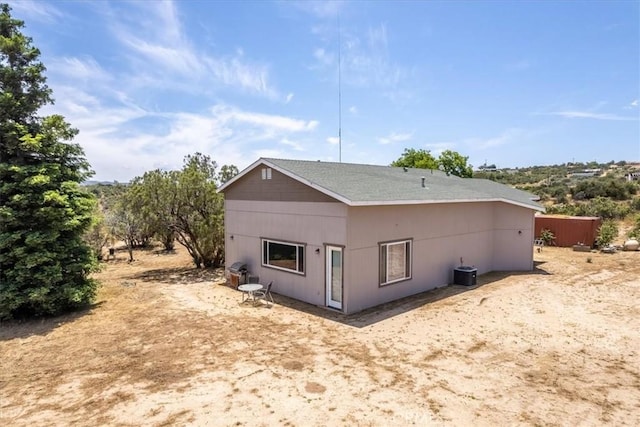 back of house with cooling unit