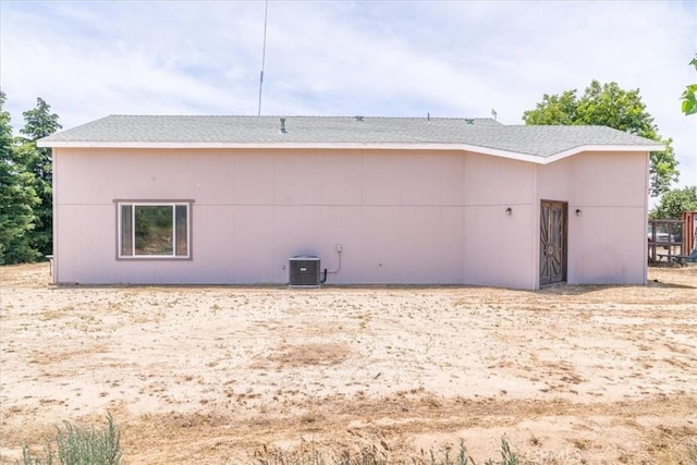 rear view of property featuring central air condition unit