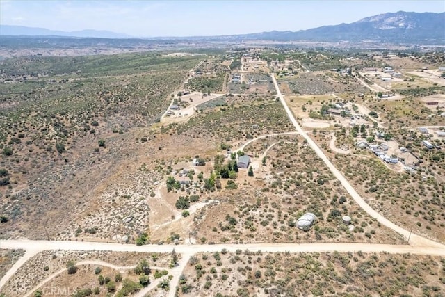 birds eye view of property featuring a mountain view and a desert view