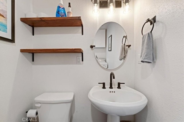 bathroom with toilet and a sink