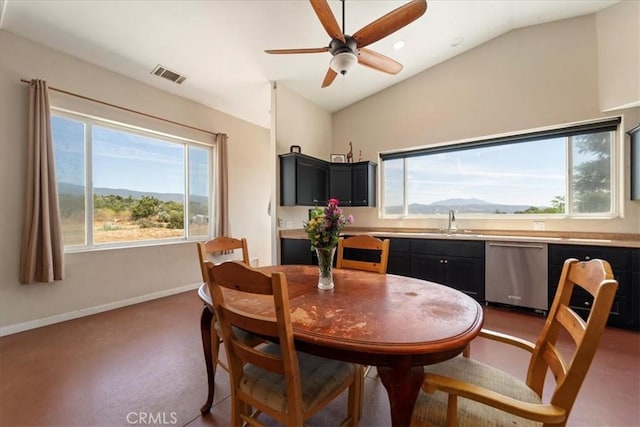 dining space featuring lofted ceiling, ceiling fan, a mountain view, visible vents, and baseboards