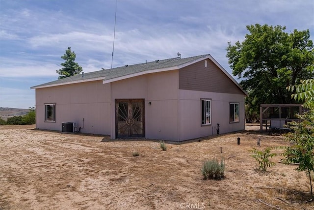 rear view of property featuring central AC unit