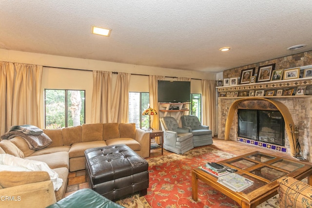 living room with a fireplace and a textured ceiling