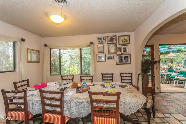 dining space featuring a textured ceiling