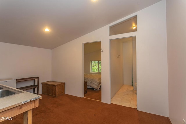 kitchen with lofted ceiling and carpet flooring