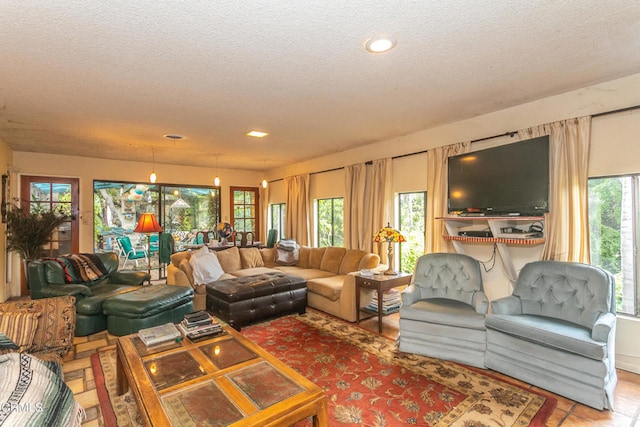 living room featuring tile patterned flooring and a textured ceiling