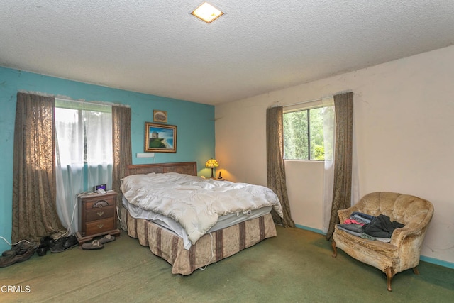 carpeted bedroom featuring a textured ceiling