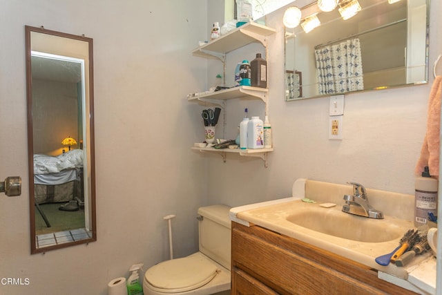 bathroom featuring vanity and toilet