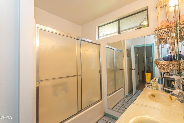 bathroom with shower / bath combination with glass door, vanity, and tile patterned flooring