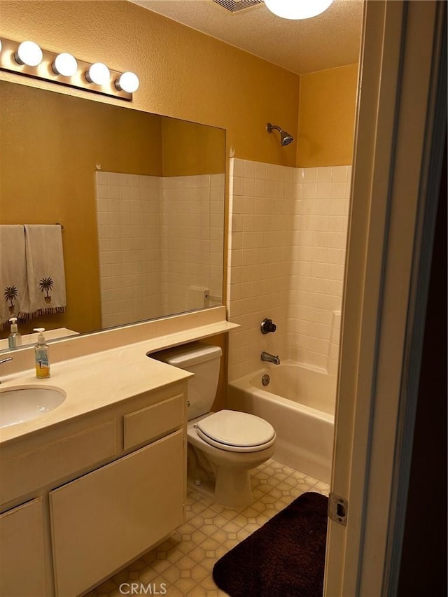 full bathroom featuring toilet, vanity, a textured ceiling, and tub / shower combination