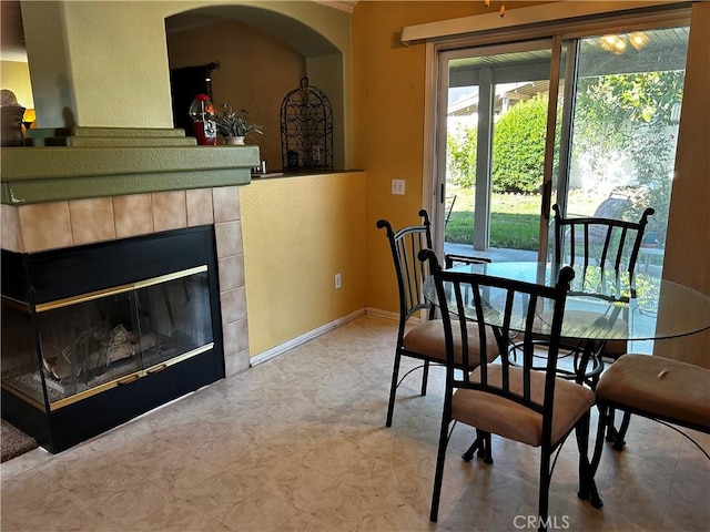 dining space with a tiled fireplace