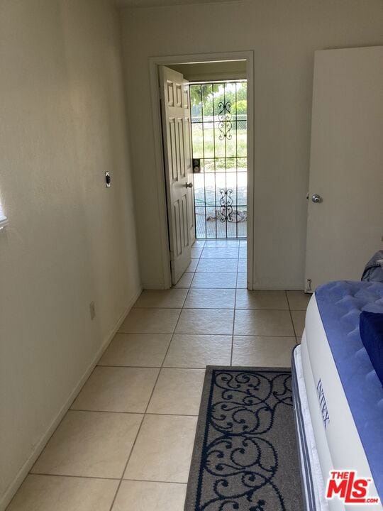 bedroom featuring access to exterior and light tile patterned floors