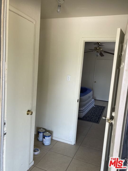 corridor featuring light tile patterned flooring