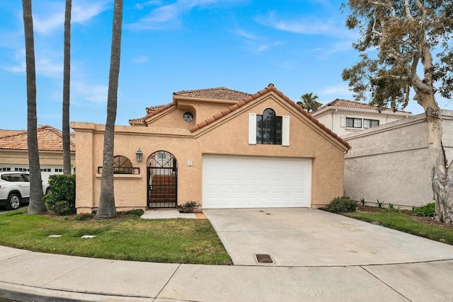 mediterranean / spanish-style home with a garage