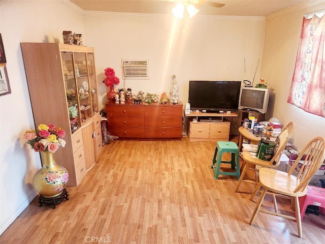 sitting room with an AC wall unit, ceiling fan, light hardwood / wood-style floors, and ornamental molding