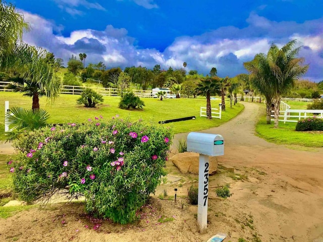 surrounding community with a lawn and a rural view