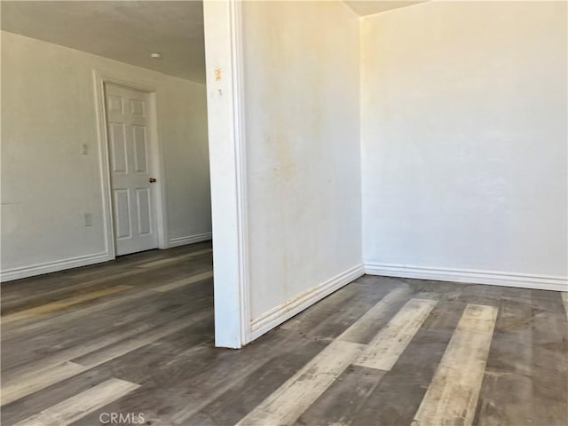 spare room with dark hardwood / wood-style floors