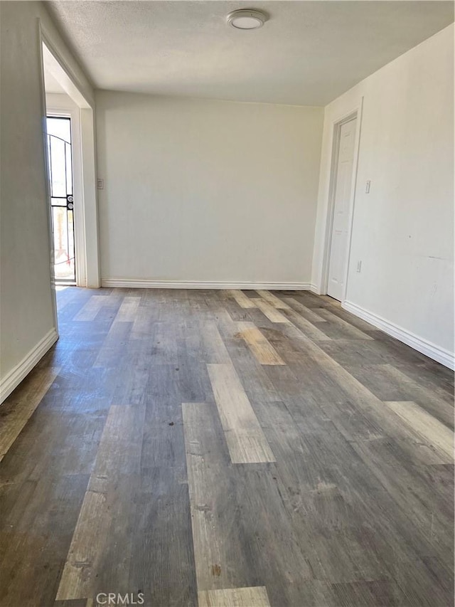 spare room featuring dark hardwood / wood-style flooring