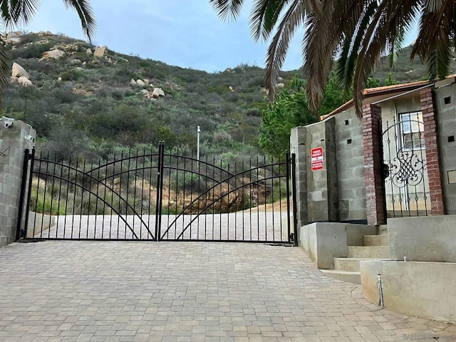 view of gate with a mountain view