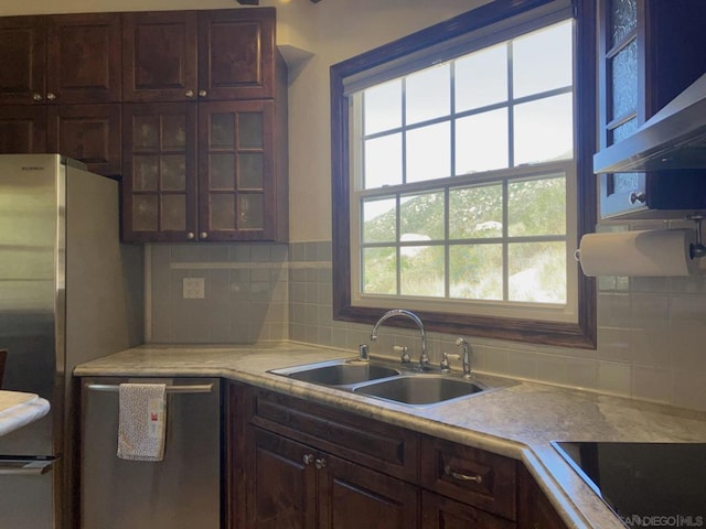 kitchen featuring a wealth of natural light, stainless steel appliances, tasteful backsplash, and sink