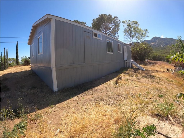 view of side of home with a mountain view