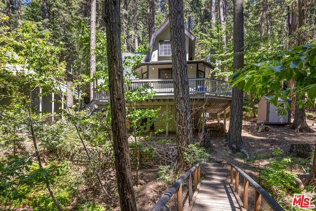 rear view of house with a wooden deck