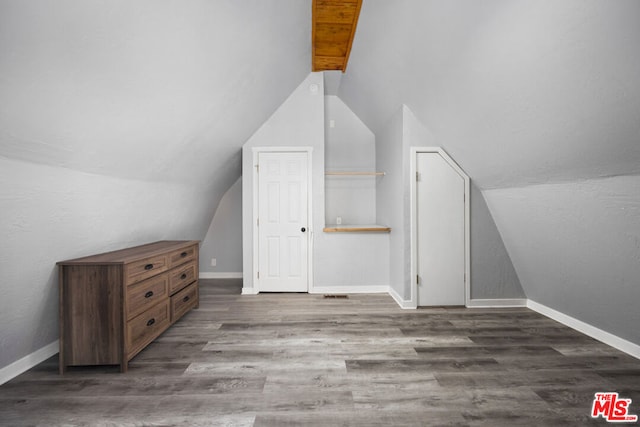 bonus room featuring lofted ceiling and dark wood-type flooring