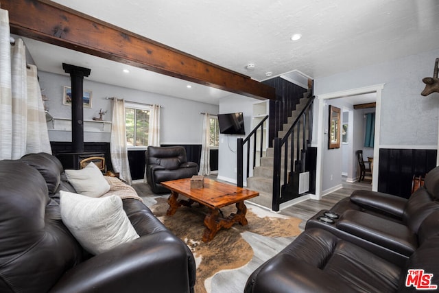 living room with beam ceiling and light hardwood / wood-style floors