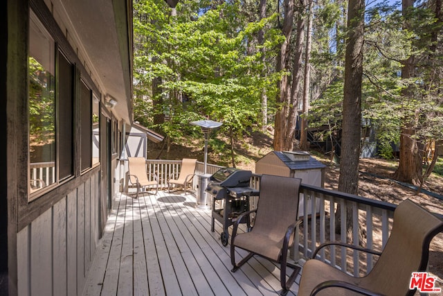 wooden terrace with a shed