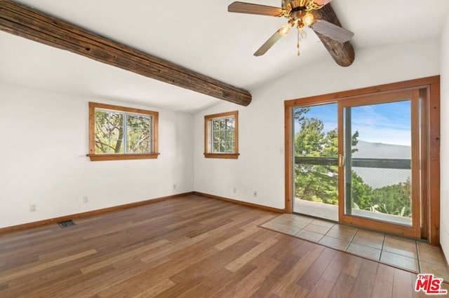 spare room featuring lofted ceiling with beams, ceiling fan, and light wood-type flooring