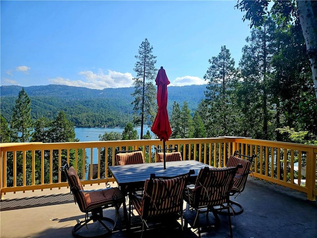 wooden deck featuring a water and mountain view