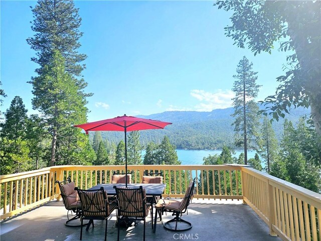 wooden deck featuring a water and mountain view