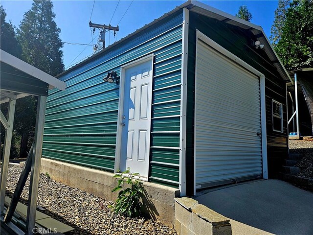 view of home's exterior with an outbuilding