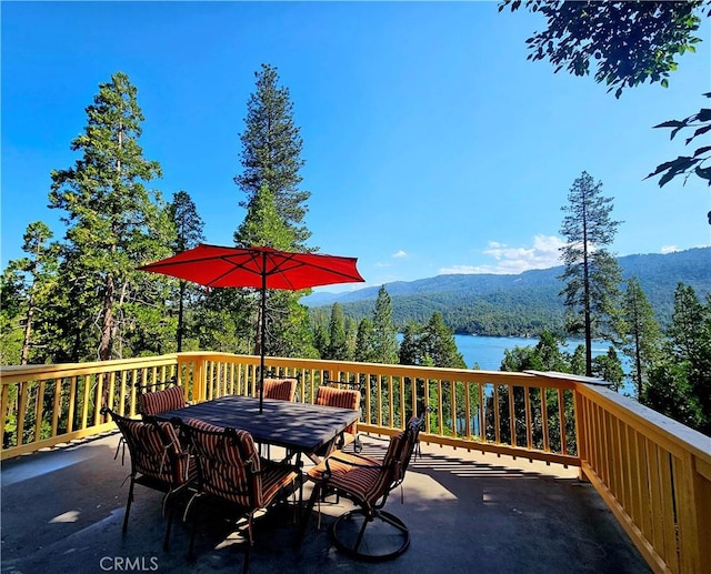 wooden deck featuring a water and mountain view