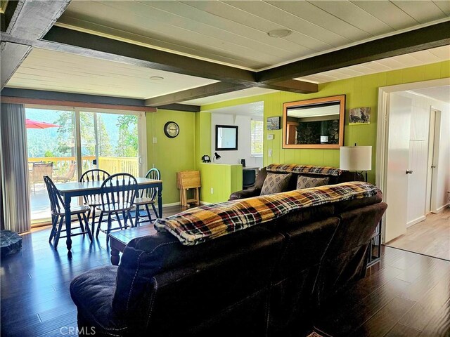 living room featuring light hardwood / wood-style floors and beamed ceiling