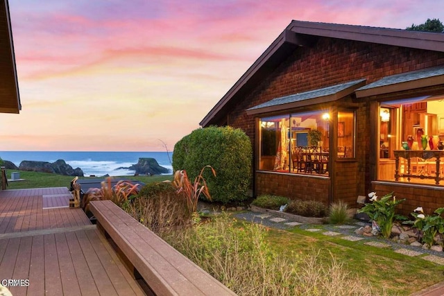 property exterior at dusk with a wooden deck