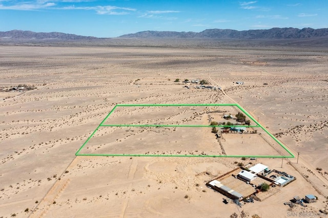 birds eye view of property with a mountain view