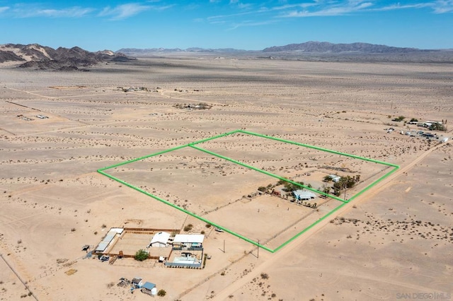 birds eye view of property featuring a mountain view