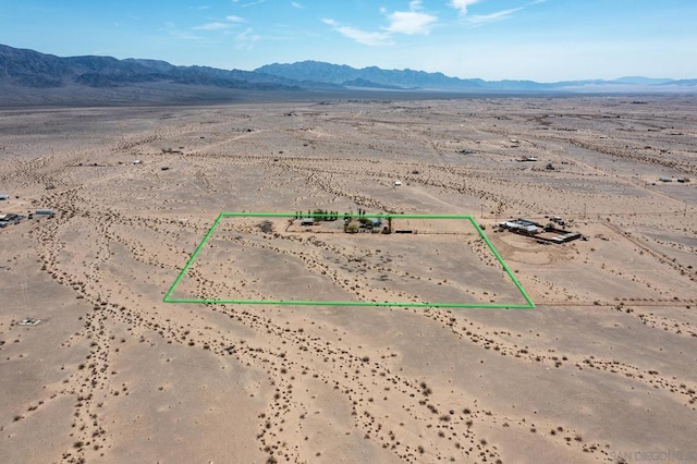 birds eye view of property with a mountain view