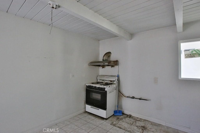 kitchen with beam ceiling, light tile patterned floors, white gas range, and wooden ceiling