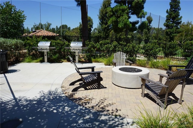 view of patio with area for grilling and an outdoor fire pit