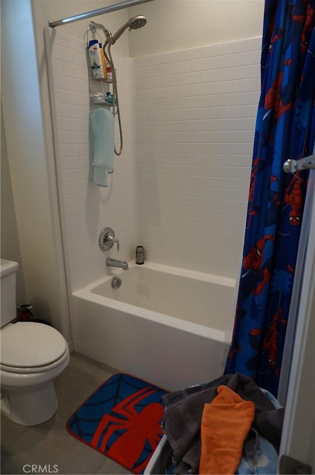 bathroom featuring shower / bath combination with curtain and toilet