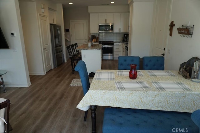 dining space with dark hardwood / wood-style floors