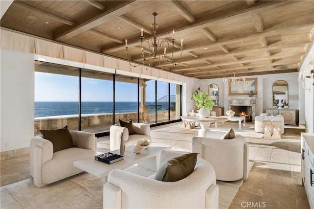 living room featuring beamed ceiling, a water view, plenty of natural light, and wood ceiling