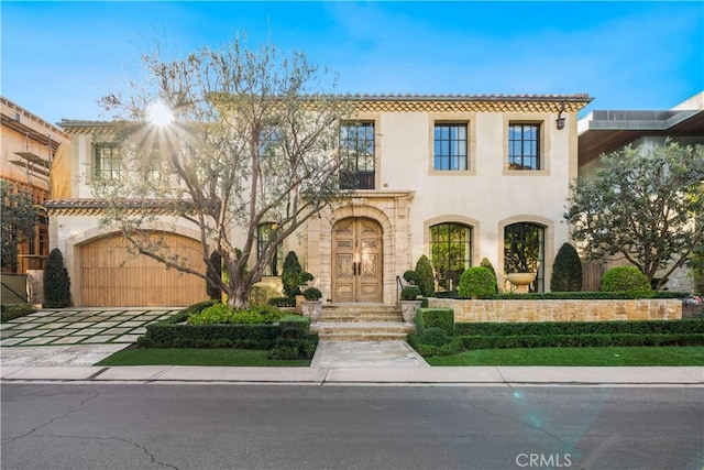 mediterranean / spanish-style house with a garage