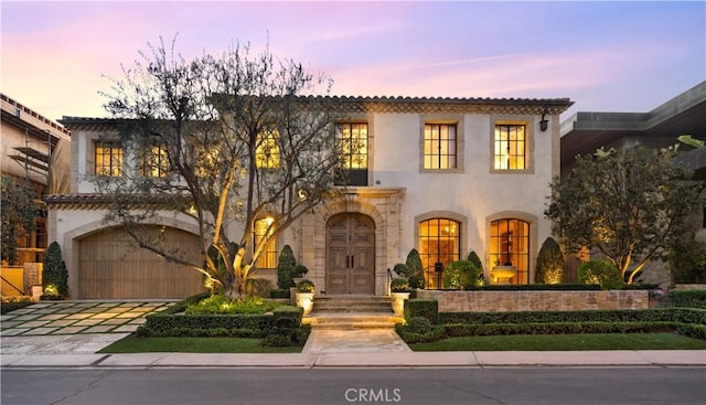 mediterranean / spanish-style home featuring a garage