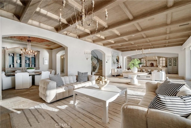 living room with beamed ceiling, wood ceiling, and an inviting chandelier