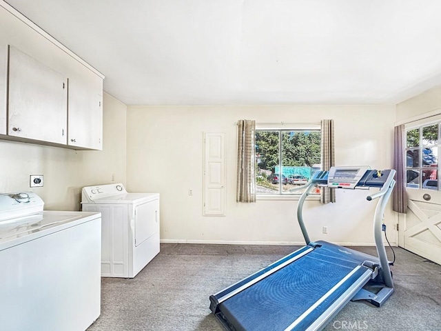 interior space with washer and clothes dryer, cabinets, and light carpet