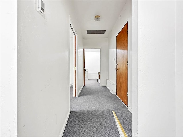 hall featuring carpet flooring